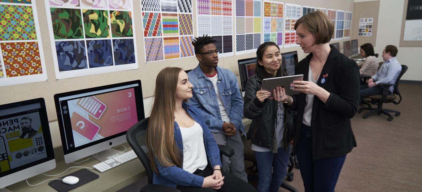 students in design studio with professor